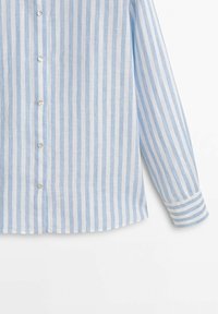 Ljusblå och vit randig skjorta med knappar och långa ärmar, gjord av lättviktig tyg. Har en rundad nederkant och subtil textur.