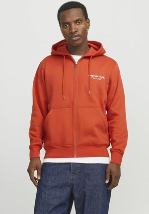Red zip-up hoodie in a smooth fabric with a kangaroo pocket, adjustable drawstring hood, and white logo text on the chest.