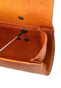 Leather pouch with a warm brown hue, featuring a smooth exterior, round metal snaps, and a textured interior. Contains a metal tool.