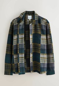 Chemise en flanelle présentant un motif à carreaux multicolore dans des nuances de vert, de marine et de jaune ; dotée d'un col et d'une fermeture à boutons, avec une texture douce.