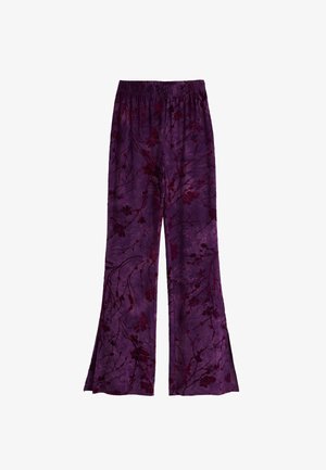Purple flowy pants featuring a floral pattern in darker shades, made from a lightweight fabric with an elastic waistband. Flared design.