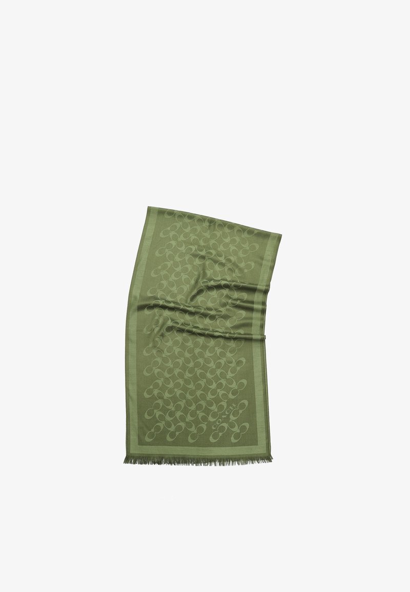 Bufanda verde con un diseño de patrones, con bordes con flecos, que presenta un diseño abstracto repetido. El material parece suave y tiene una textura lisa.