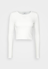 Vit långärmad crop-top i ribbat tyg. Har rund halsringning och figurnära passform, utan synliga mönster eller accenter.
