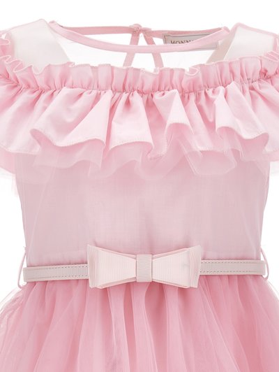 Light pink dress featuring a ruffled neckline, sheer tulle overlay, and a matching bow at the waist. Detailed with a soft, textured finish.