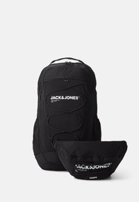 Black backpack and small bag set, made of durable fabric. Features a front logo, bungee cord design, and zippered compartments.