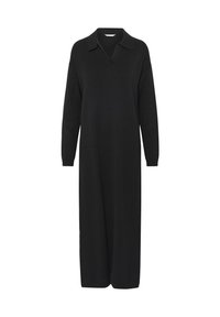 Robe noire à manches longues en tissu tricoté, avec un col rabattu et une coupe droite et ample qui arrive à mi-mollet.