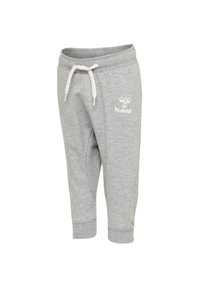 Grå träningsoveraller med dragsko i midjan, med ribbade muddar och en vit logotyp på vänster ben. Tillverkade av mjukt, strukturerat tyg.