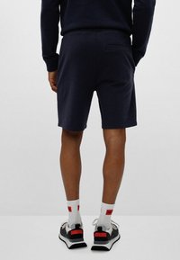 HUGO DIZ - Tracksuit bottoms - dark blue