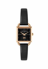 Montre carrée Ted Baker avec un cadran noir, des accents dorés et un détail en nœud texturé. Elle est dotée d'un bracelet en cuir noir et d'éléments en métal doré.