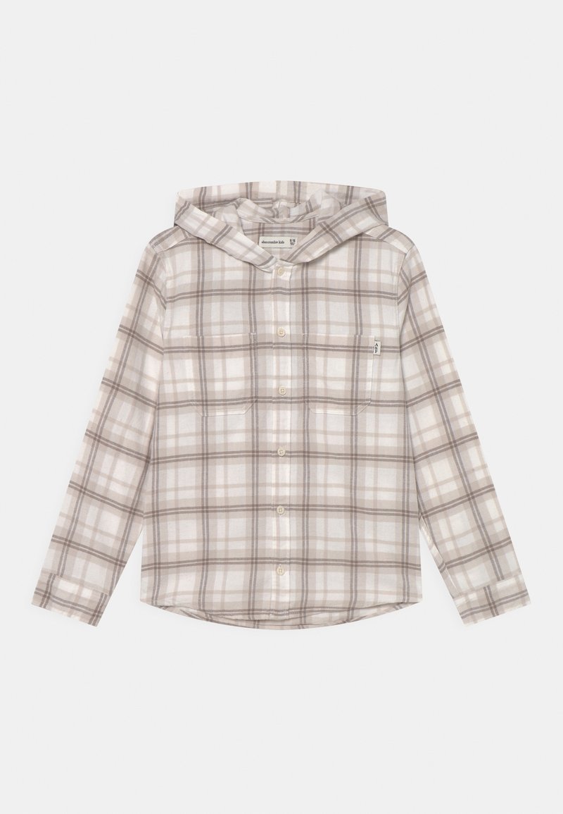 Kaptur z jasnym kratkowanym wzorem w odcieniach beżu, brązu i bieli, z zapięciem na guziki i dwiema przednimi kieszeniami. Miękka tekstura materiału.