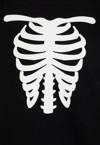 Black sweatshirt featuring a large white skeleton ribcage graphic printed on the front. The design is bold with clear outlines and details.
