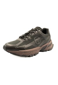 Black athletic shoe with a textured upper, brown rubber sole, and integrated lacing system; features a circular logo on the side.
