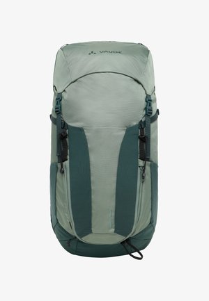 Sac à dos vert avec une surface texturée, présentant des accents vert foncé, des bretelles ajustables et un compartiment zippé. Le logo apparaît en haut.
