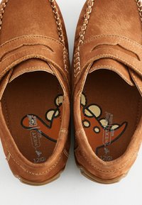 Brune ruskinds slip-on sko med stikninger og en glat finish, med mønstret indre og polstrede såler.