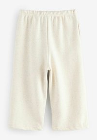 Ljusbeige shorts i en mjuk, texturerad tyg. Elastisk midja, två sidofickor och subtila flerfärgade prickar genom hela.