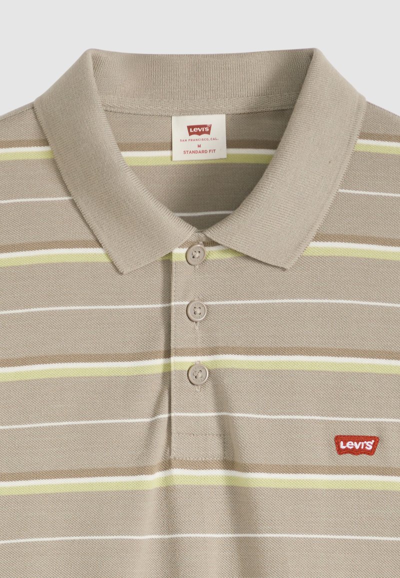 Beige Levi's polo shirt with short collar, three buttons, and horizontal stripes in white, brown, and light green. Levi's logo patch on chest.