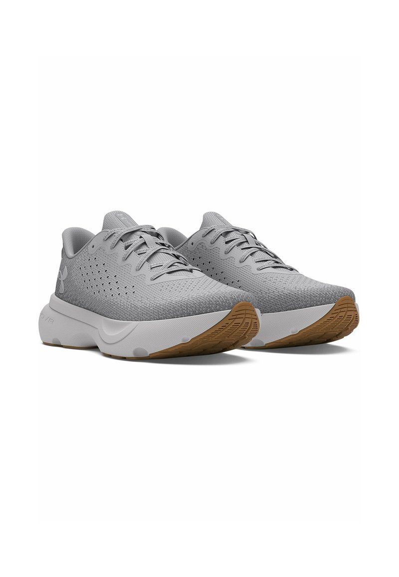 Buty sportowe z szarym dzianinowym wierzchem, lekką konstrukcją, białą podeszwą środkową i texturedową gumową podeszwą. Posiadają sznurowanie oraz perforacje.