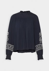 Marineblaue Bluse mit gerafftem Kragen, fließenden Ärmeln und gestickten Blumenmustern an den Manschetten und dem Saum. Glattes, leichtes Material.