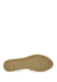 Schoenzool met een getextureerde rubberen zool, voorzien van een golvend patroon en beige kleur, omrand met een zachte, witte harige voering.