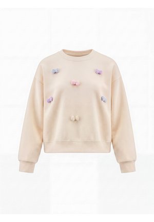 Beige sweatshirt med stofsløjfer i pastelfarver fastgjort foran, jævnt fordelt over bryst og torso, vist på en ensfarvet baggrund.