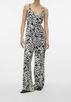 Combinaison imprimée zèbre en noir et blanc, coupe décontractée, jambes larges, ceinture ajustable à nouer et encolure creusée profonde. Tissu lisse et léger.