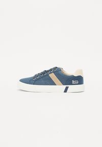 Blue canvas sneakers with beige accents, textured surface, round toe, white rubber sole, and Lee logo on the side.