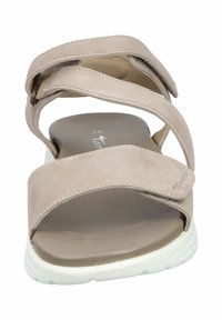 Beige suede sandals with three cross straps, cushioned insole, and white rubber sole. Designed for comfort and casual wear.