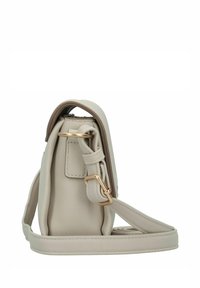 Sac à main en cuir beige avec une forme structurée, quincaillerie en ton doré, une bandoulière détachable et un sommet arrondi. Surface texturée avec un minimum de détails.