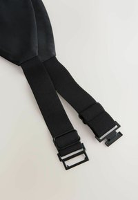 Black elastic straps with ribbed texture, featuring adjustable metal buckles for fastening, designed for durability and comfort.