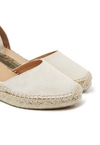 Light beige suede espadrilles with a jute rope sole, featuring a closed toe and side cutouts for breathability. Smooth texture, simple design.