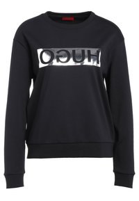 Felpa nera in misto cotone, con logo "HUGO" metallizzato argento sul petto. Scollo rotondo e polsini a costine.