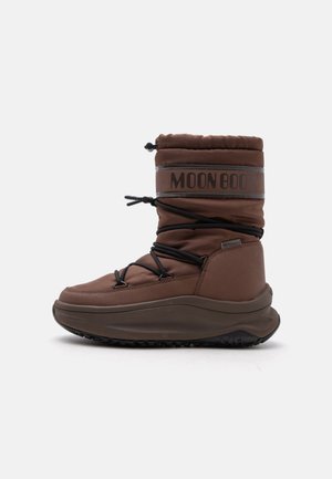 Brown insulated winter boot with thick sole, black lace-up detail, and "MOON BOOT" label on the padded upper shaft.