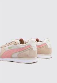 Zapatillas de ante y malla beige con acentos en rosa y verde, que cuentan con una suela acolchada y un logo en el lateral.