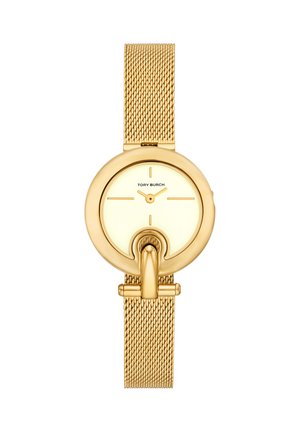 Zegarek na rękę Tory Burch w odcieniu złota z bransoletą typu mesh, okrągłą minimalistyczną tarczą i unikalnym elementem w kształcie podkowy na dole pośrodku.