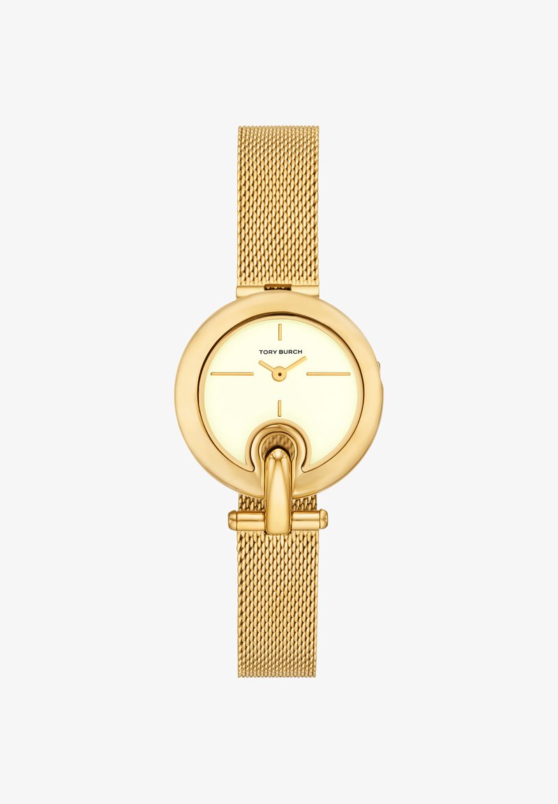 Montre-bracelet Tory Burch ton or avec bracelet en maille, cadran rond minimaliste et détail unique en forme de fer à cheval au centre en bas.