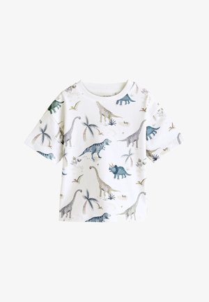 Chemise blanche pour enfants à manches courtes avec des illustrations colorées de dinosaures et de palmiers aux tons bleu, vert et beige.