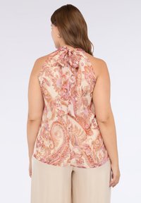 Top con scollo all'americana in beige chiaro con motivo paisley rosa e viola. Tessuto morbido e leggero con dettaglio a fiocco al collo. Texture liscia.