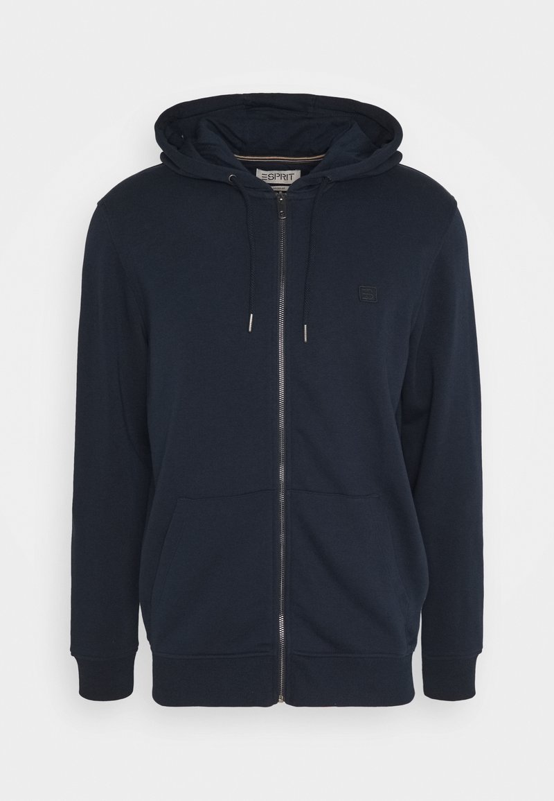 Sweat à capuche zippé bleu marine avec cordon de serrage à la capuche, poches kangourou à l'avant, poignets côtelés et petit patch logo sur la poitrine.