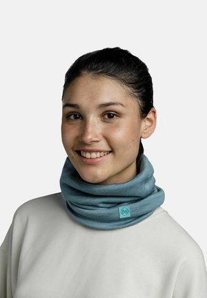 Light blue multifunctional neck gaiter made of soft fabric, featuring a brand tag. Worn comfortably around the neck.