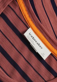 Red and navy striped fabric with an orange neckline; features a tag labeled "icebreaker" indicating size M.