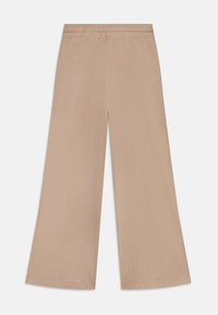 Pantaloni beige a gamba larga con vita elasticizzata. Realizzati in un tessuto morbido con una leggera trama e piccoli motivi a pois distribuiti ovunque.