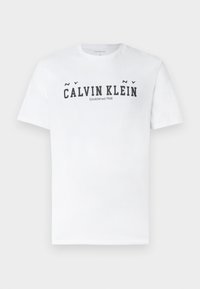 Valge lühikeste varrukatega T-särk musta tekstiga "NY CALVIN KLEIN Established 1968" rinnal, ümara kaelusega ja tavapärase lõikega.
