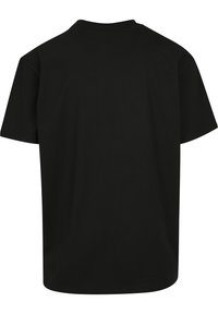 Sort bomulds T-shirt med korte ærmer, rund hals og almindelig pasform. Glat tekstur uden mønstre eller synlige logoer. Set fra ryggen.