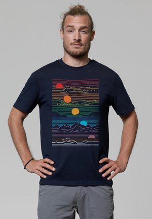 Navy blue t-shirt featuring a multicolored graphic design of sun and mountain silhouettes with horizontal lines and various colors.
