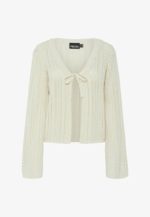 Neulejakku luonnonvalkoisena, jossa on V-pääntie, pitkät hihat, avoin etuosa ja solmimisclosure. Sisältää tekstuurisen, avoimen neulekuvion.