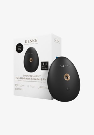 Black, egg-shaped facial hydration refresher with a gold accent. Textured packaging features branding and product details in black and white.