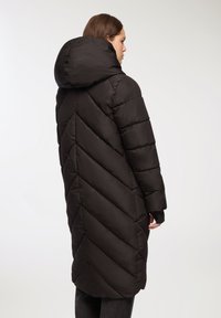 Czarna kurtka puchowa z kapturem, z pikowanym wzorem w zygzak, długimi rękawami i średniej długości krojem zapewniającym ciepło i osłonę.