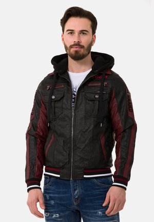 Leather jacket featuring a textured black body, maroon accents, a zip front, and a hood. Includes multiple zippered pockets and striped cuffs.
