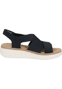 Czarne sandały na koturnie z krzyżującymi się paskami, miękką tekstylną cholewką i teksturowaną białą gumową podeszwą z detalami przypominającymi jutę.