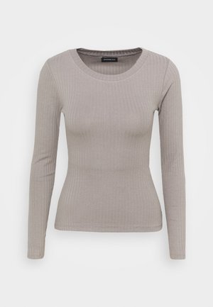 Long-sleeve ribbed top in light grey fabric, featuring a round neckline and fitted silhouette with subtle texture.